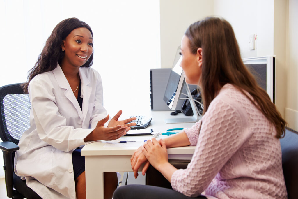 patient having consultation with female doctor in office